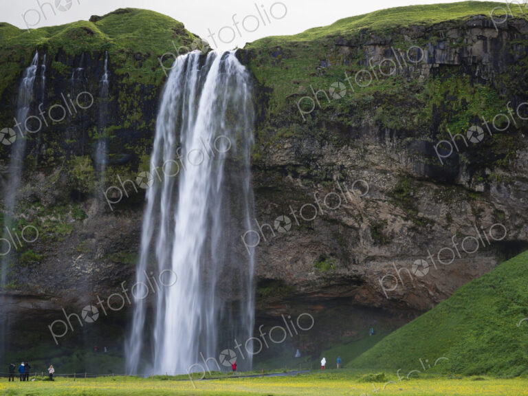A waterfall cascade over a sheer cliff.