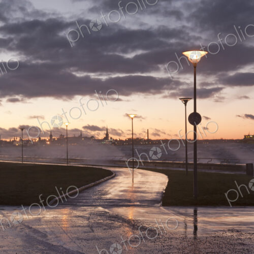 A weather storm, black clouds and waves crashing over the waterfront