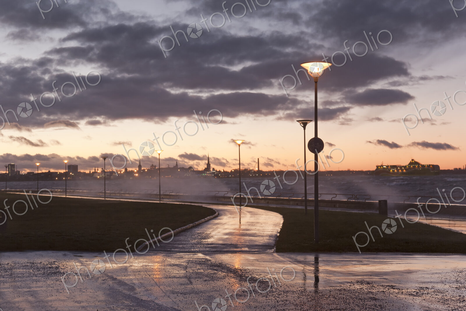 A weather storm, black clouds and waves crashing over the waterfront