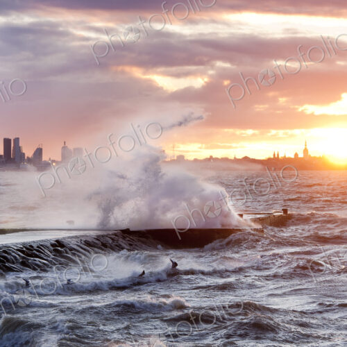 A weather storm in the Baltic Sea, waves crashing over a pier A weather storm in the Baltic Sea, waves crashing over a pier
