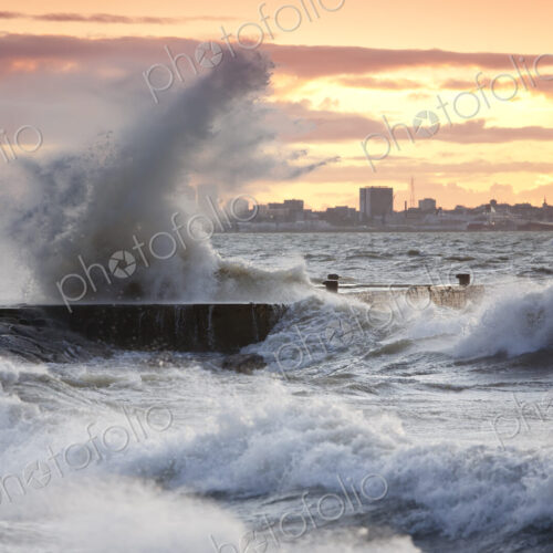 A weather storm in the Baltic Sea, waves crashing over a pier A weather storm in the Baltic Sea, waves crashing over a pier