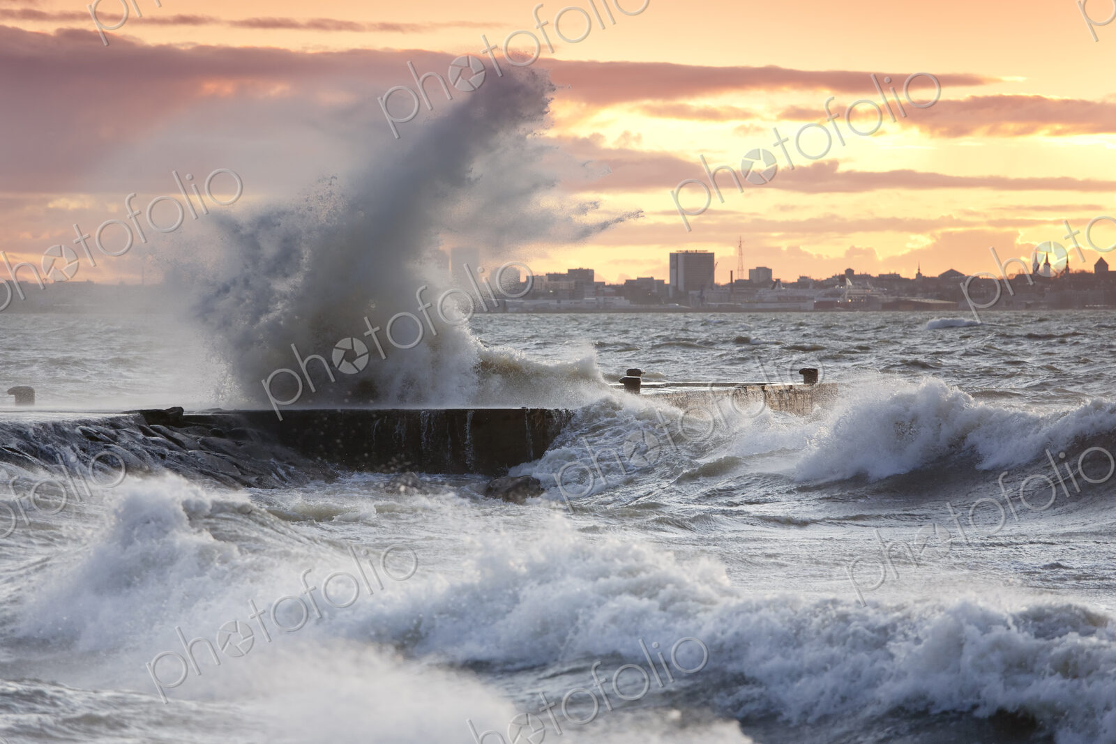 A weather storm in the Baltic Sea, waves crashing over a pier