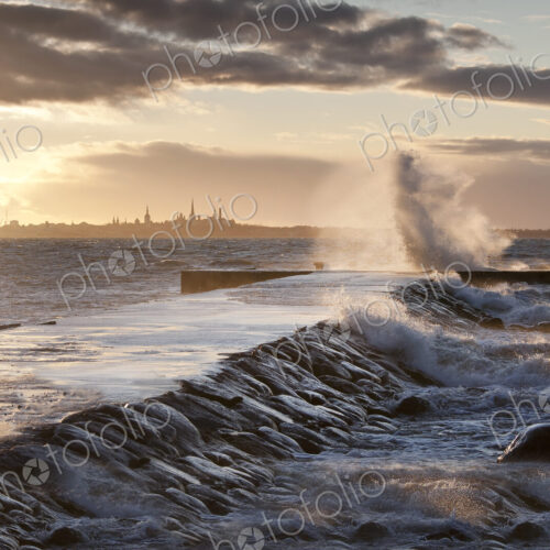 A weather storm in the Baltic Sea, waves crashing over a pier A weather storm in the Baltic Sea, waves crashing over a pier