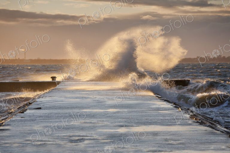 A weather storm, waves crashing over a waterfront promenade and coastline