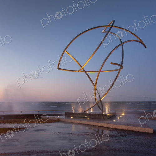 A weather storm, waves crashing over the waterfront promenade and metal sculpture A weather storm, waves crashing over the waterfront promenade and metal sculpture