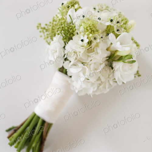 A wedding bouquet. White cut flowers, green seed heads, and foliage. Green stems and…