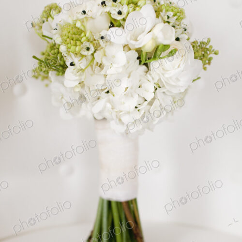 A wedding bouquet. White cut flowers, green seed heads, and foliage. Green stems and…