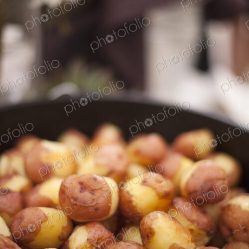 A wedding buffet meal. A dish of partly peeled new potatoes. A wedding buffet meal. A dish of partly peeled new potatoes.