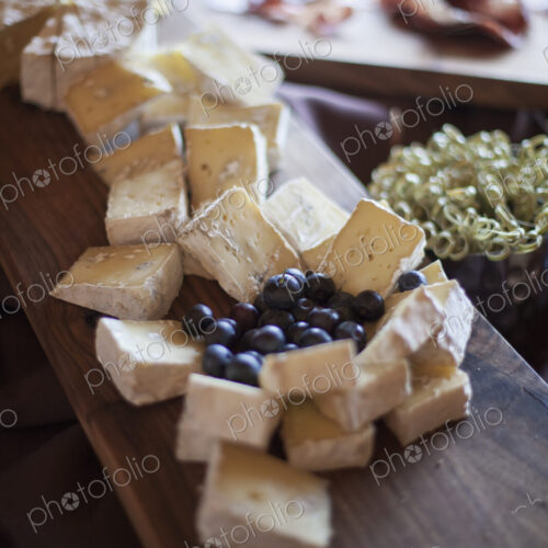 A wedding party meal. A cheeseboard, with soft cheeses cut into triangles, and fresh… A wedding party meal. A cheeseboard, with soft cheeses cut into triangles, and fresh…