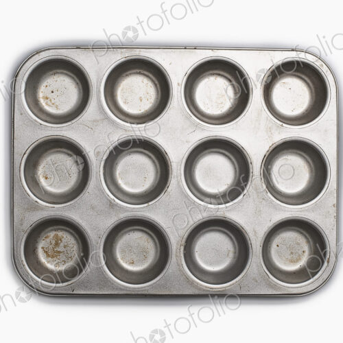 A well used, seasoned baking tray. Cookware. A cupcake or muffin tin.