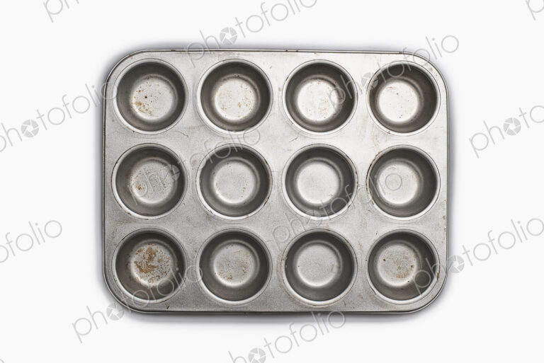 A well used, seasoned baking tray. Cookware. A cupcake or muffin tin.