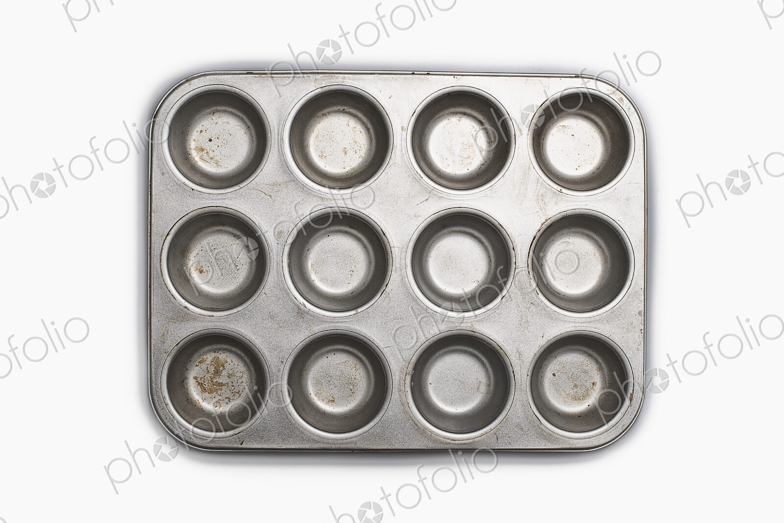 A well used, seasoned baking tray. Cookware. A cupcake or muffin tin.