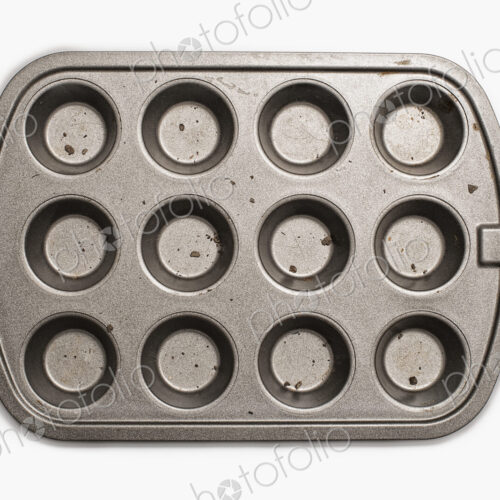 A well used, seasoned baking tray. Cookware. A cupcake or muffin tin.