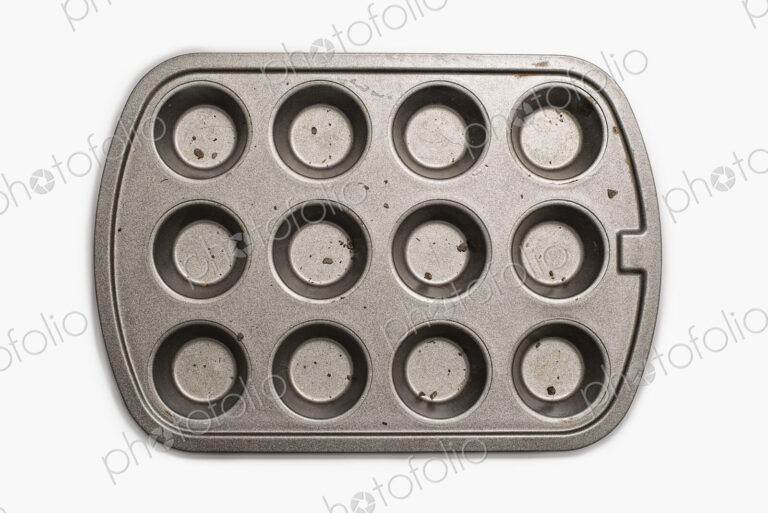 A well used, seasoned baking tray. Cookware. A cupcake or muffin tin.
