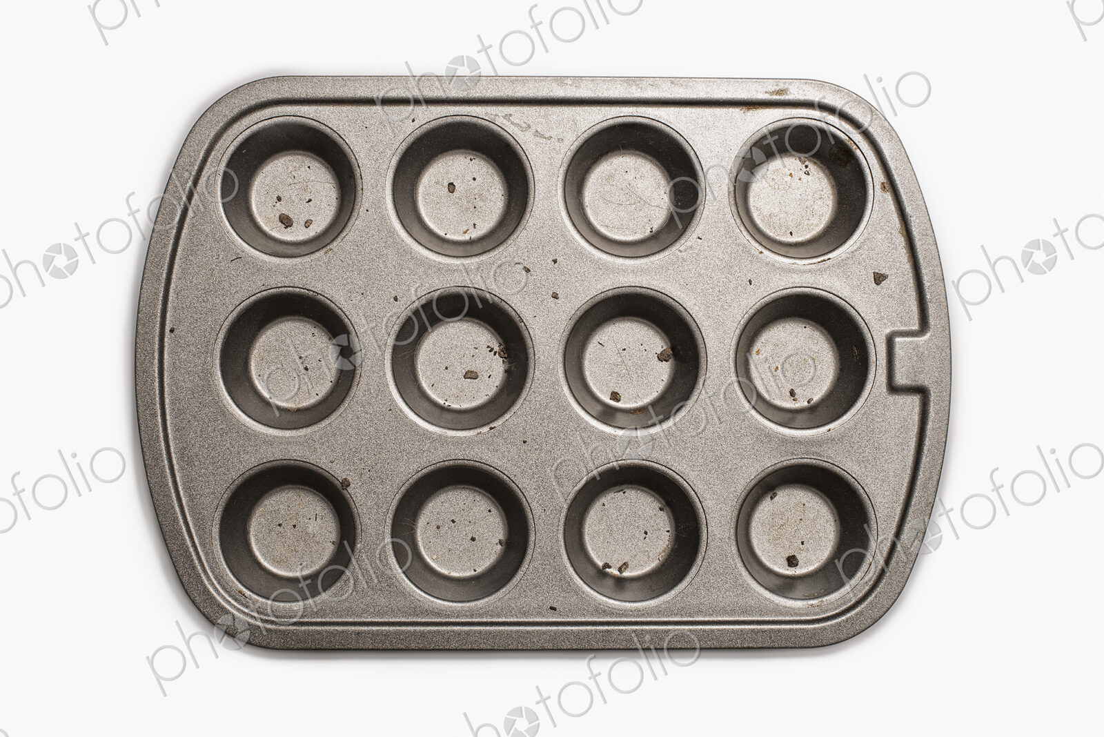 A well used, seasoned baking tray. Cookware. A cupcake or muffin tin.