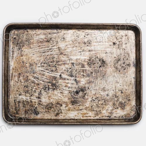 A well used, seasoned baking tray. Cookware. Baking sheet.