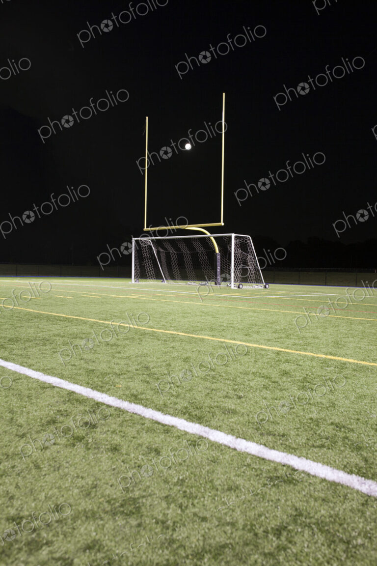 A white ball between the posts on a sports field, scoring