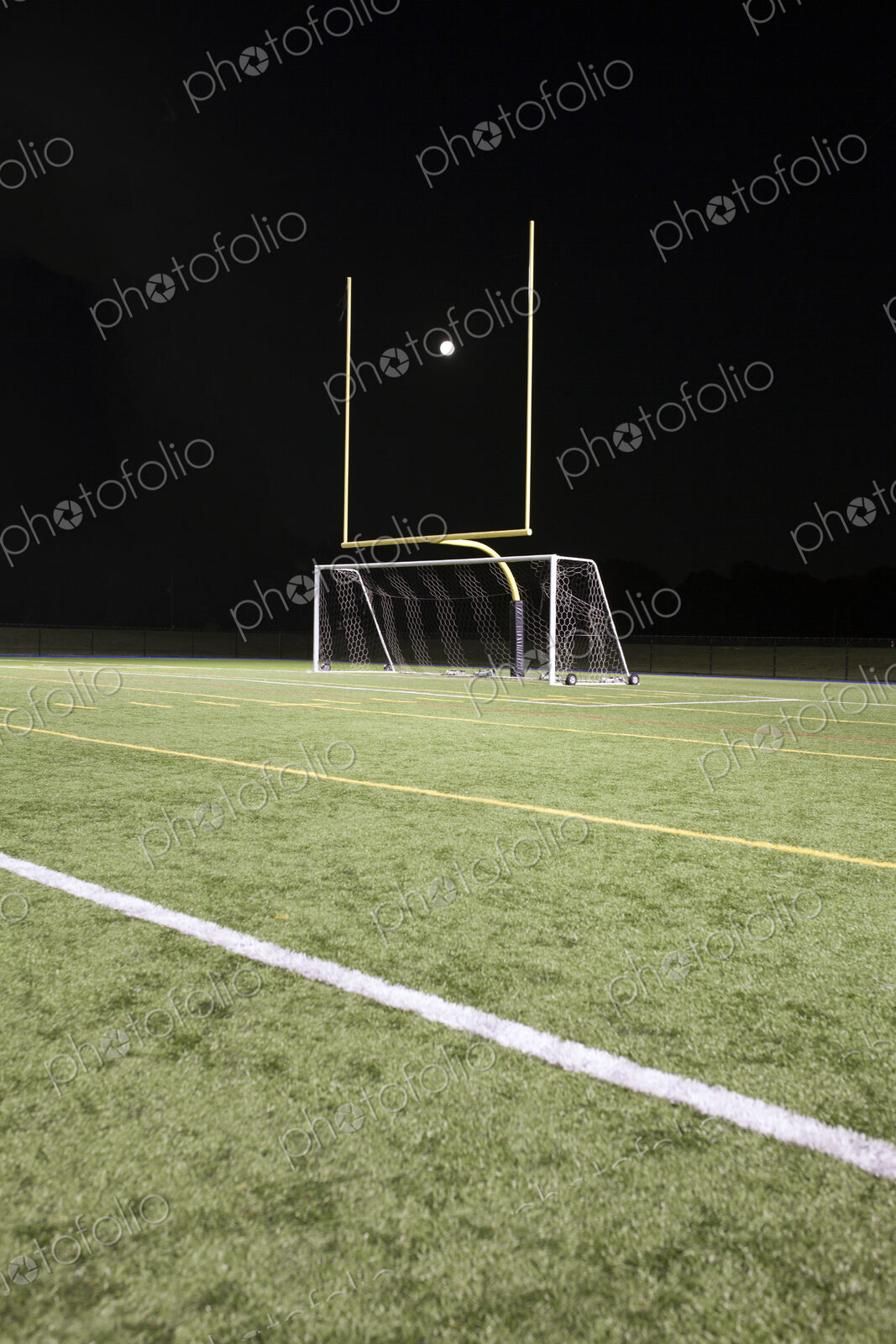 A white ball between the posts on a sports field, scoring
