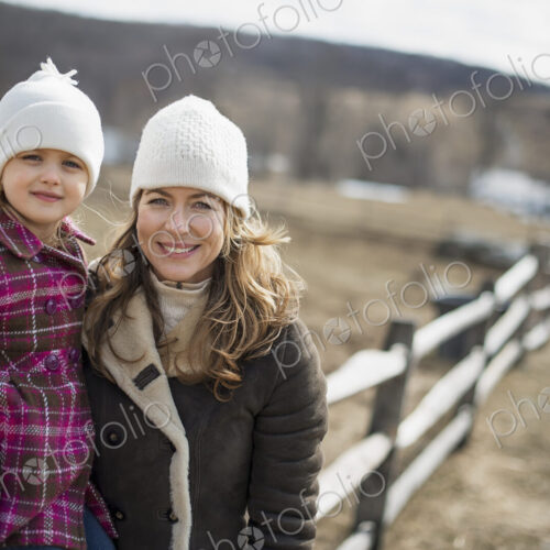 A woman and child walking along a path hand in hand. A woman and child walking along a path hand in hand.