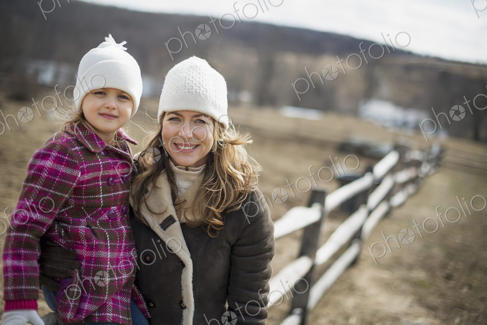 A woman and child walking along a path hand in hand.