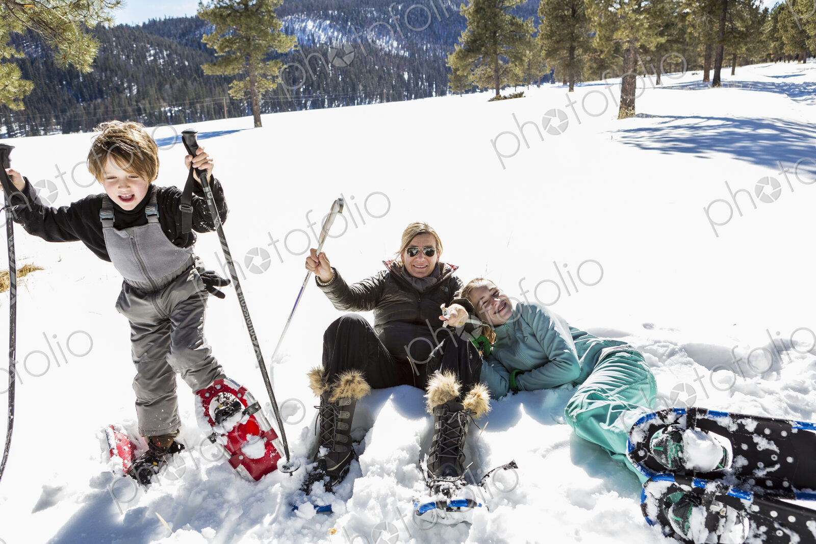 A woman and two children in snow shoes in thick snow