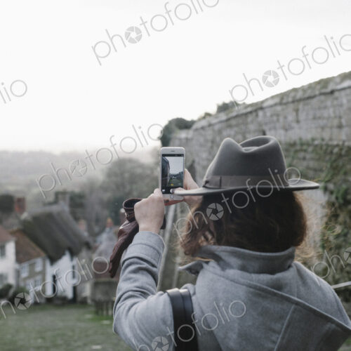 A woman at the top of Gold Hill, a steep cobbled street in Shaftesbury.