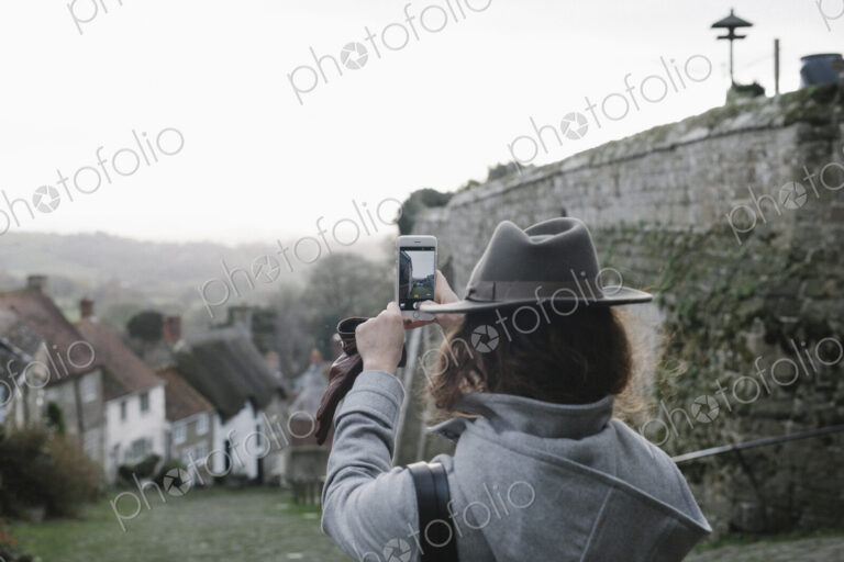 A woman at the top of Gold Hill, a steep cobbled street in Shaftesbury.