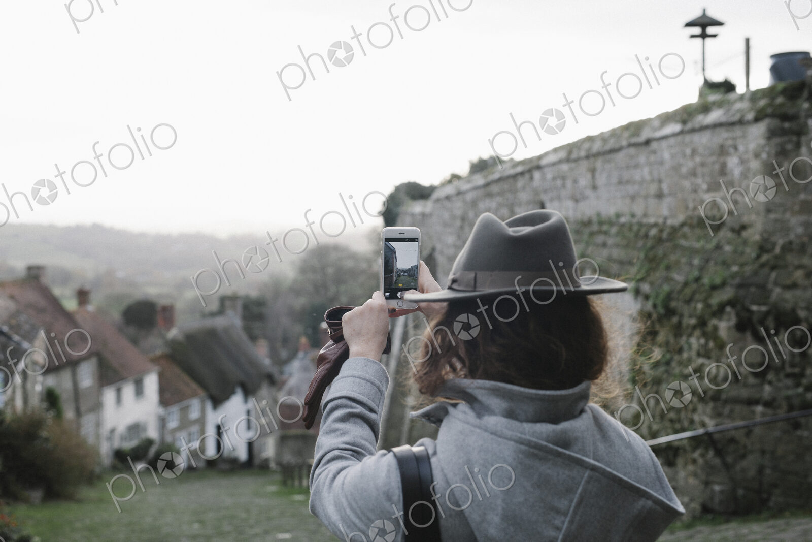 A woman at the top of Gold Hill, a steep cobbled street in Shaftesbury.