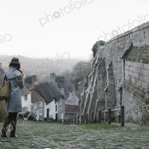 A woman at the top of Gold Hill, a steep cobbled street in Shaftesbury. A woman at the top of Gold Hill, a steep cobbled street in Shaftesbury.