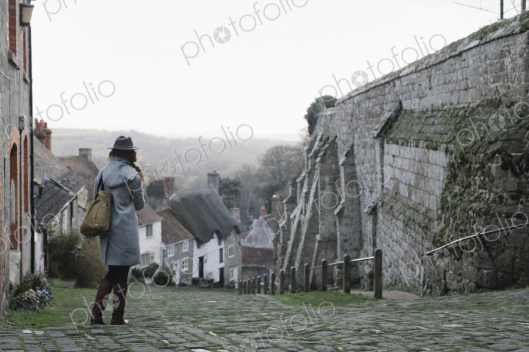 A woman at the top of Gold Hill, a steep cobbled street in Shaftesbury.
