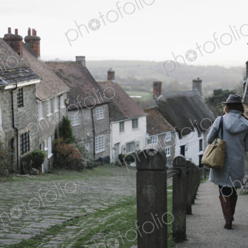 A woman at the top of Gold Hill, a steep cobbled street in Shaftesbury.