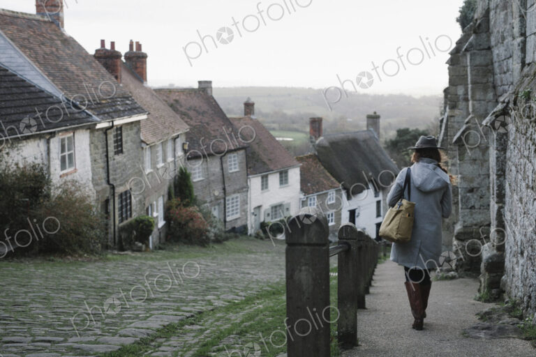 A woman at the top of Gold Hill, a steep cobbled street in Shaftesbury.