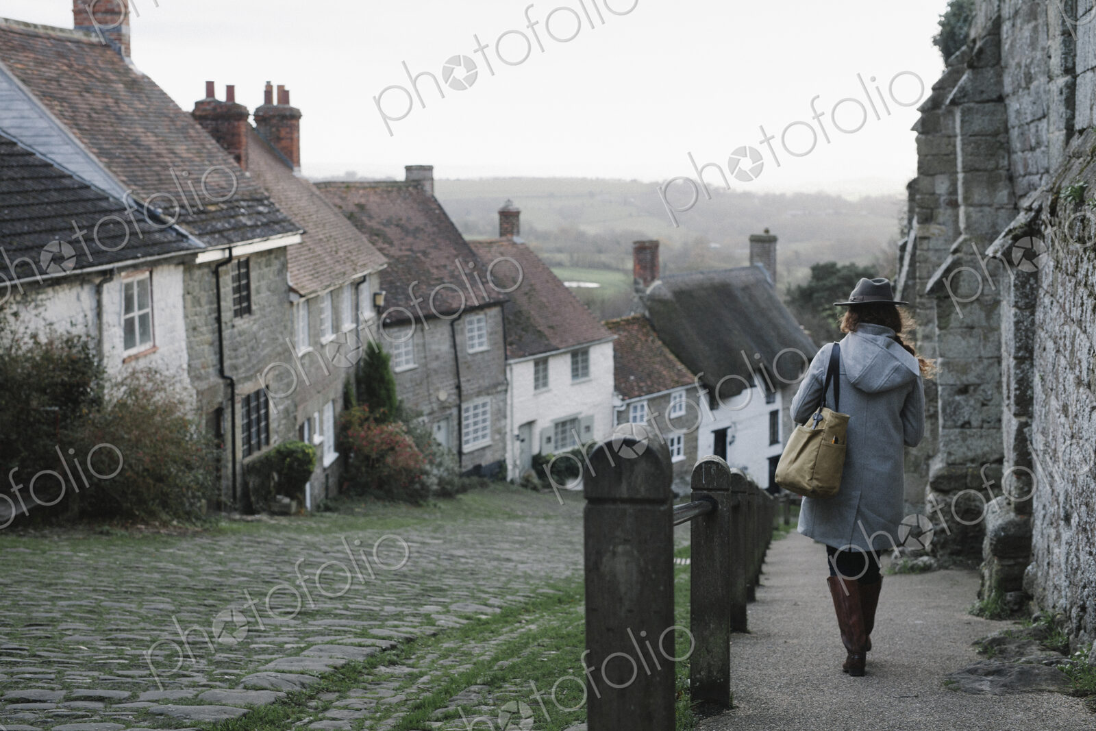 A woman at the top of Gold Hill, a steep cobbled street in Shaftesbury.