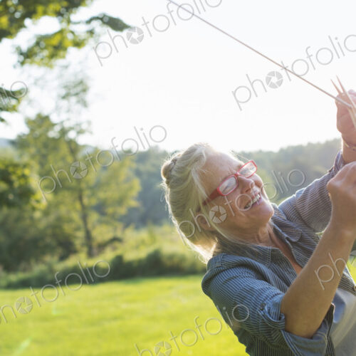 A woman hanging laundry on the washing line, in the fresh air.