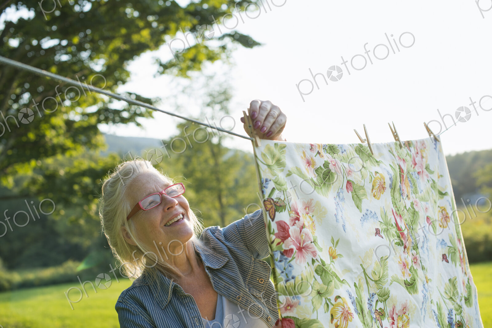 A woman hanging laundry on the washing line, in the fresh air.