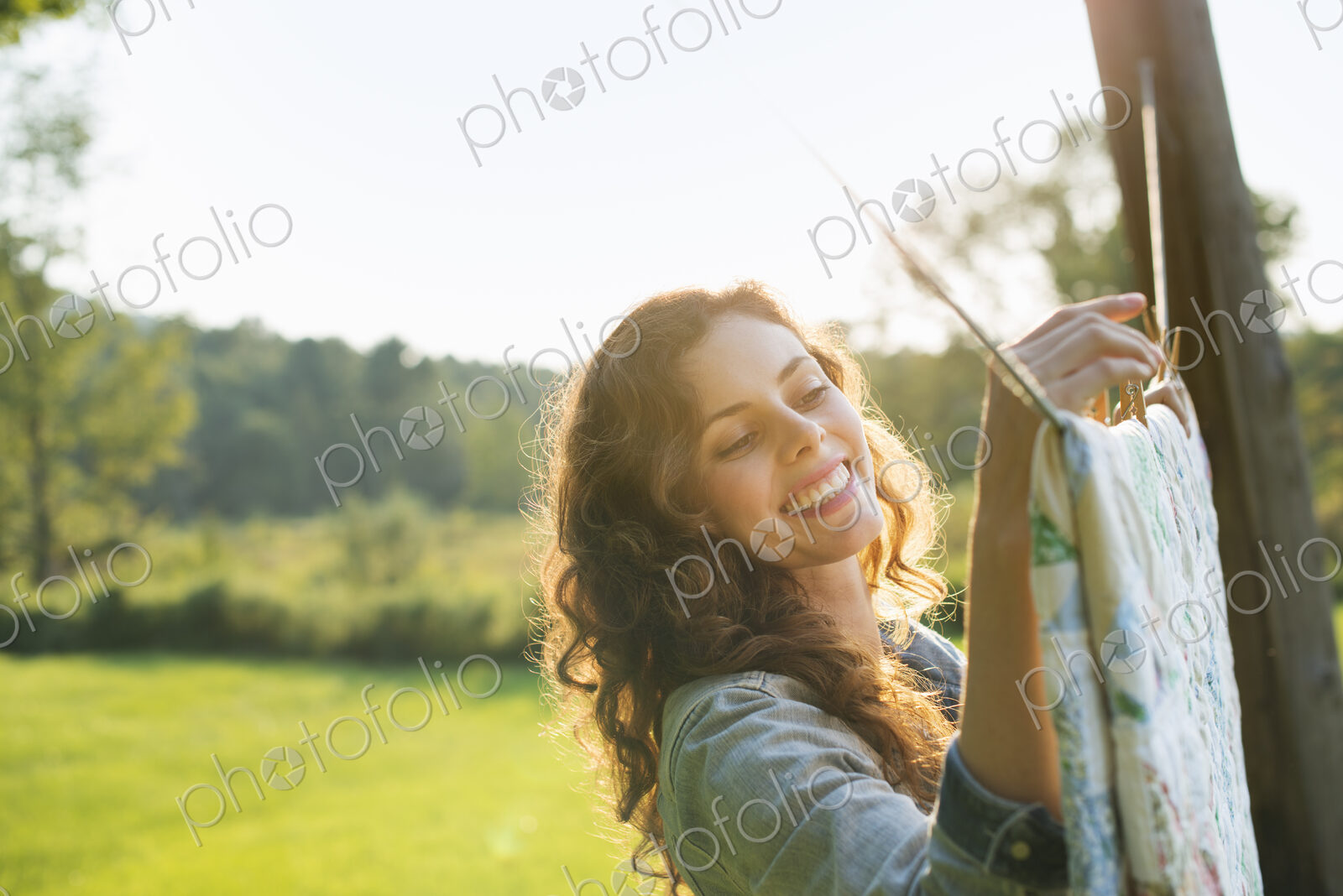 A woman hanging laundry on the washing line, in the fresh air.