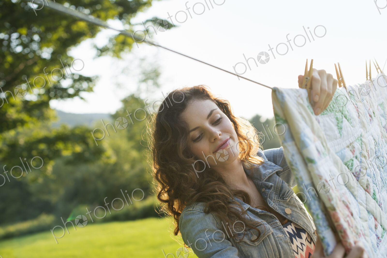 A woman hanging laundry on the washing line, in the fresh air.