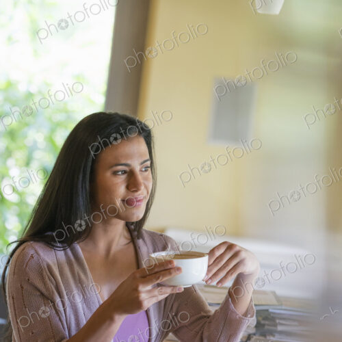 A woman having a cup of coffee. A woman having a cup of coffee.