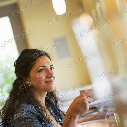 A woman having a cup of coffee. A woman having a cup of coffee.