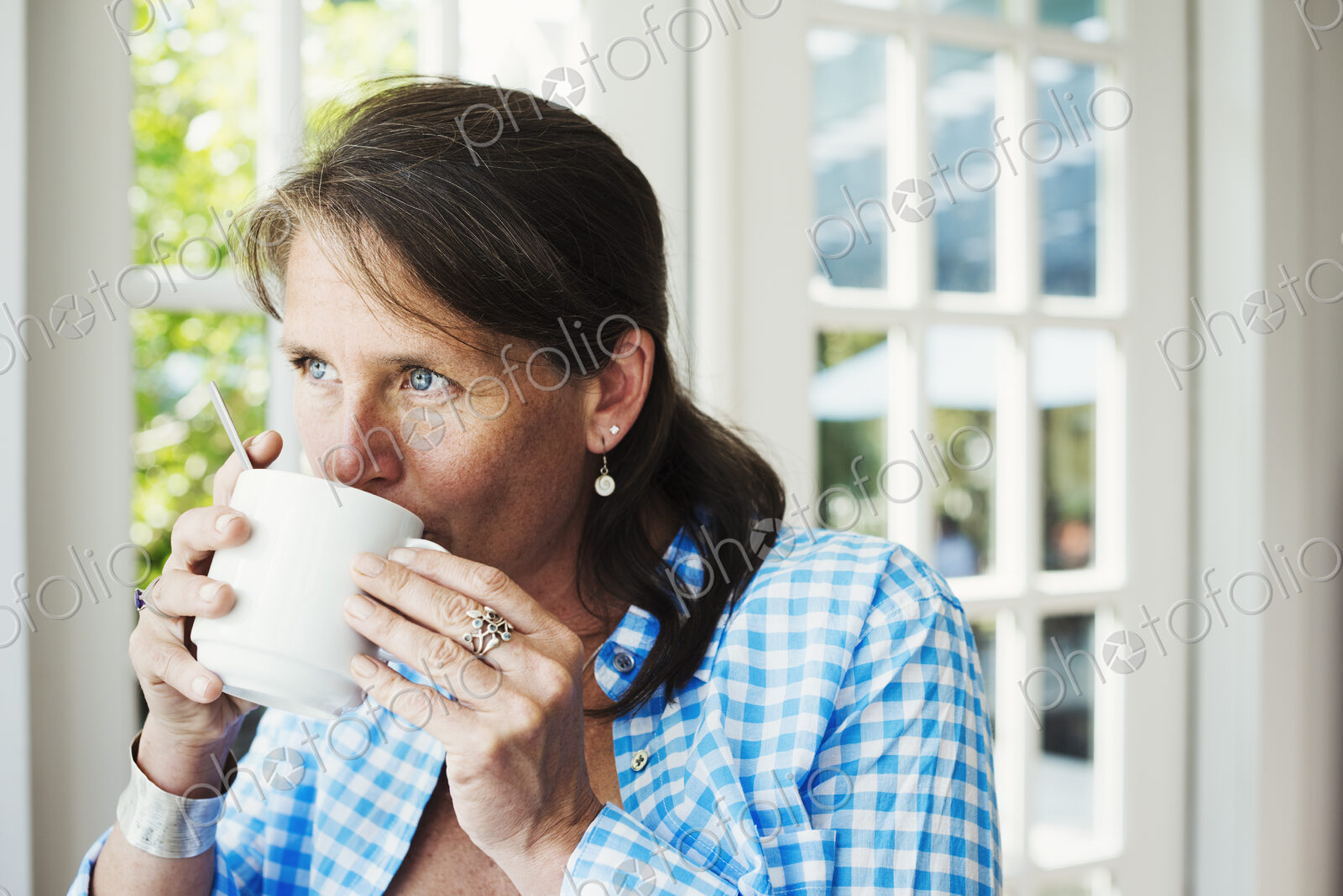 A woman having a cup of coffee.
