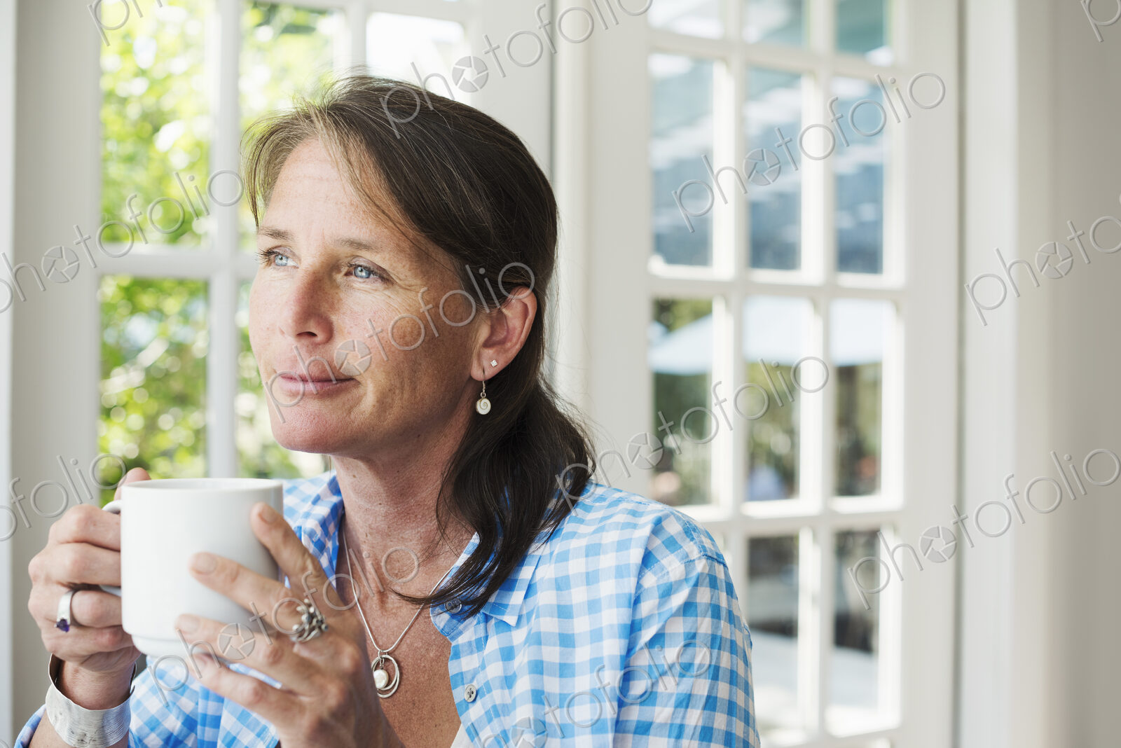 A woman having a cup of coffee.