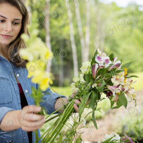 A woman holding a bunch of summer garden flowers.