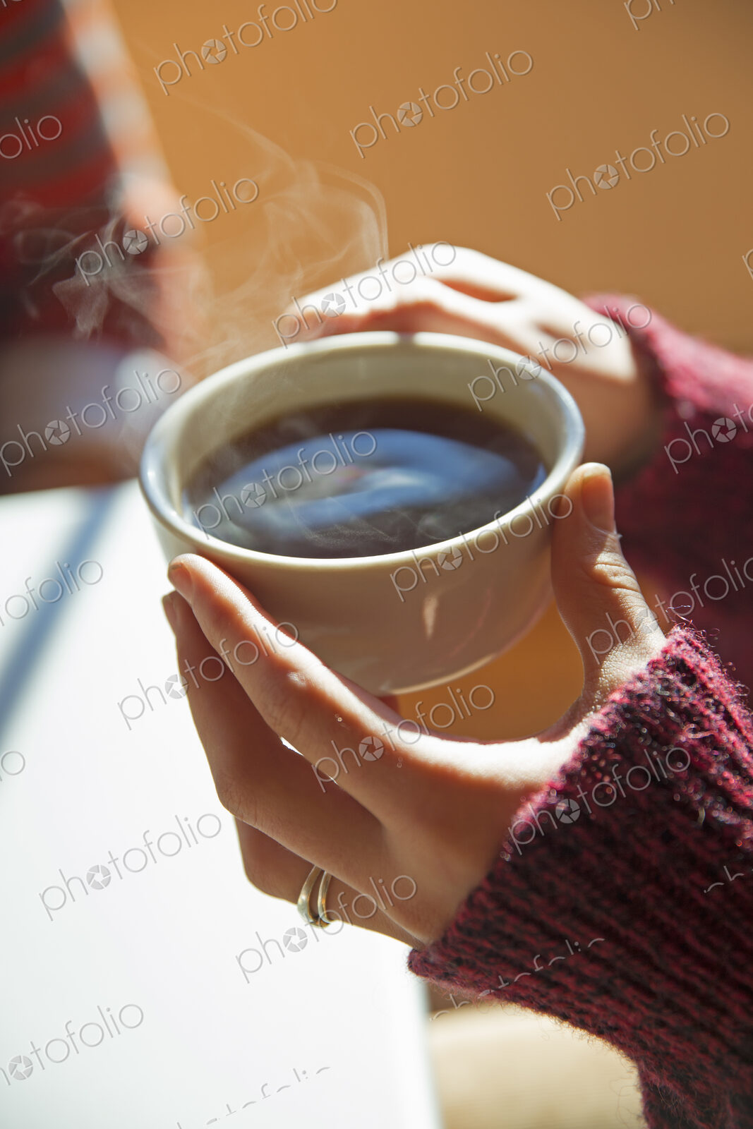 A woman holding a cup of hot coffee in her hands.
