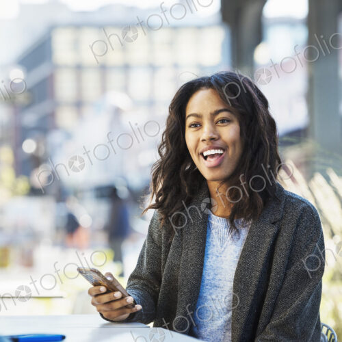 A woman holding a mobile phone, talking to a man on a city street. A woman holding a mobile phone, talking to a man on a city street.