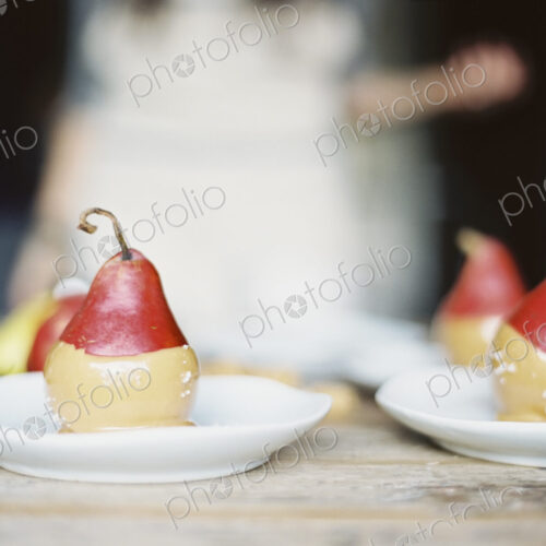 A woman in a domestic kitchen. Fresh organic pears dipped into a sauce for dessert… A woman in a domestic kitchen. Fresh organic pears dipped into a sauce for dessert…
