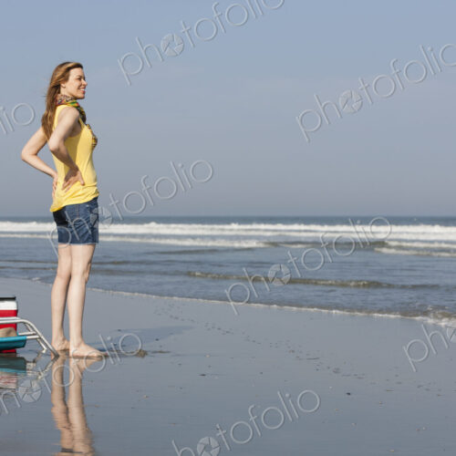 A woman in a sunhat and scarf on the beach on the New Jersey Shore, at Ocean City. A woman in a sunhat and scarf on the beach on the New Jersey Shore, at Ocean City.