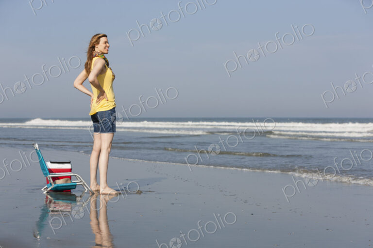 A woman in a sunhat and scarf on the beach on the New Jersey Shore, at Ocean City.