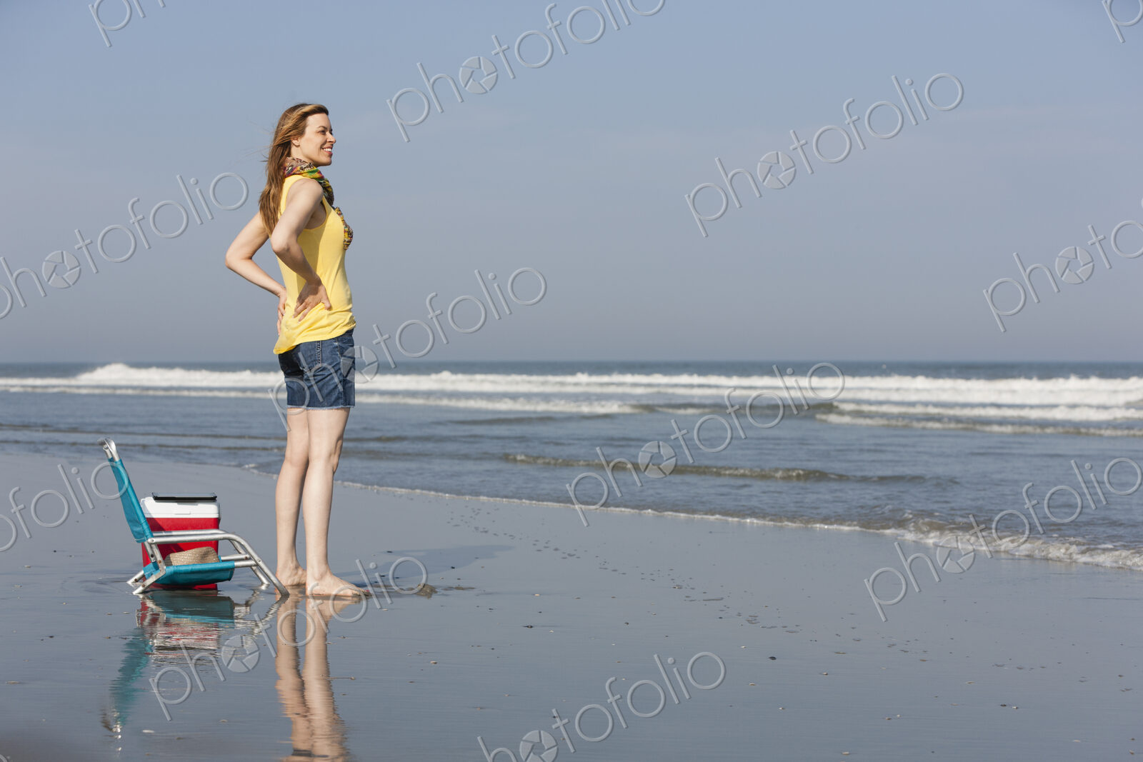 A woman in a sunhat and scarf on the beach on the New Jersey Shore, at Ocean City.