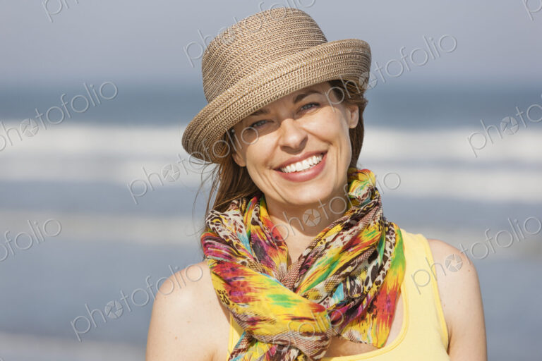 A woman in a sunhat and scarf on the beach on the New Jersey Shore, at Ocean City.