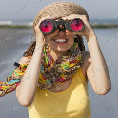 A woman in a sunhat and scarf on the beach on the New Jersey Shore, at Ocean City.